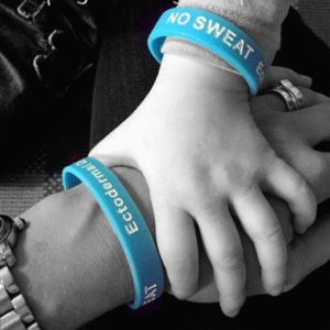 image of a child and mother holding hands in black and white, both wearing blue ED society wristbands