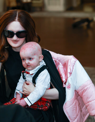 Baby Noah is sat on our Ambassador Hannah's lap